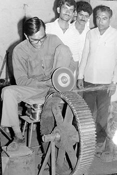 Mr. Popatbhai Chauhan doing welding work on machine