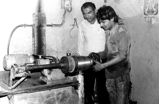 A young boy making oil mill machine in Chetan Agro industries